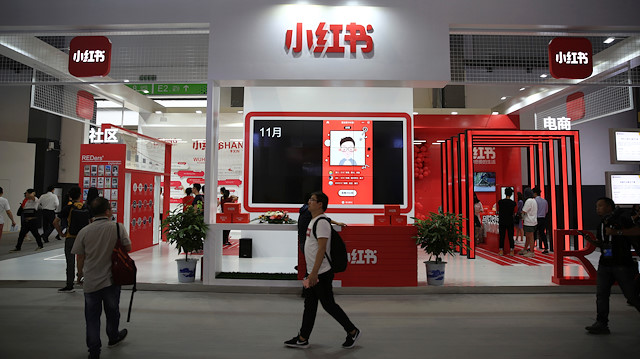 File photo: A man walks past the booth of Chinese startup Xiaohongshu, which means "little red book" in Chinese, at the Big Data Expo in Guiyang, Guizhou province