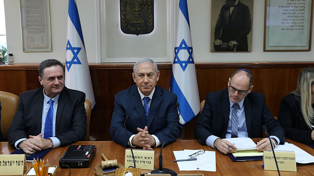 File photo: Israeli Prime Minister Benjamin Netanyahu (C), Transportation and Intelligence Minister Yisrael Katz (L) and Deputy Cabinet Secretary Lior Natan attend the weekly cabinet meeting at his office in Jerusalem 