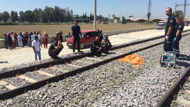 Olayın ardından acılı baba, rayların üzerinde yatan kızının cansız bedenine bakarken.