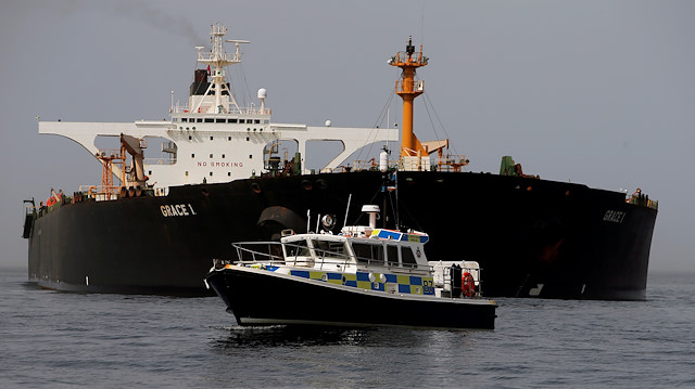 FILE PHOTO: A Royal Gibraltar Police's boat guards the Iranian oil tanker Grace 1 as it sits anchored after it was seized earlier this month by British Royal Marines off the coast of the British Mediterranean territory on suspicion of violating sanctions against Syria, in the Strait of Gibraltar, southern Spain July 20, 2019. REUTERS/Jon Nazca/File Photo


