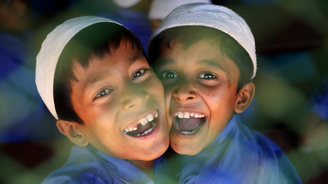 Rohingya refugee boys who study in an Islamic school smile as they react to the camera at a refugee camp in Cox's Bazar, Bangladesh, April 9, 2019. REUTERS/Mohammad Ponir Hossain

