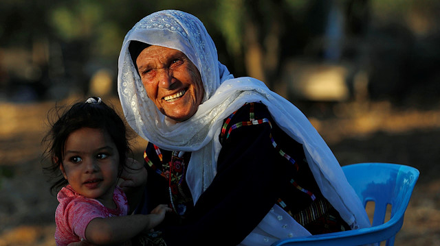 Muftia, the grandmother of U.S. congresswoman Rashida Tlaib, is seen with her granddaughter outside her house in the village of Beit Ur Al-Fauqa in the Israeli-occupied West Bank August 16, 2019. Picture taken August 16, 2019. REUTERS/Mohamad Torokman

