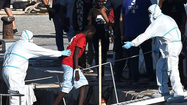 A minor who was among migrants stranded on the Spanish migrant rescue ship Open Arms disembarks in Lampedusa, Italy August 17, 2019. 