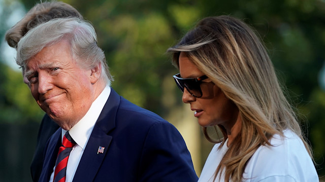 U.S. President Donald Trump smiles as he walk with First Lady Melania Trump and their son Barron (behind Trump) on the South Lawn of the White House upon their return to Washington from Bedminster, New Jersey, U.S., August 18, 2019. REUTERS/Yuri Gripas

