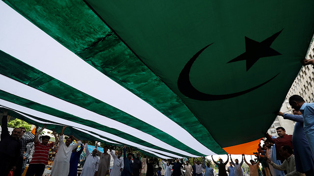 People carry an Azad Kashmir's flag 