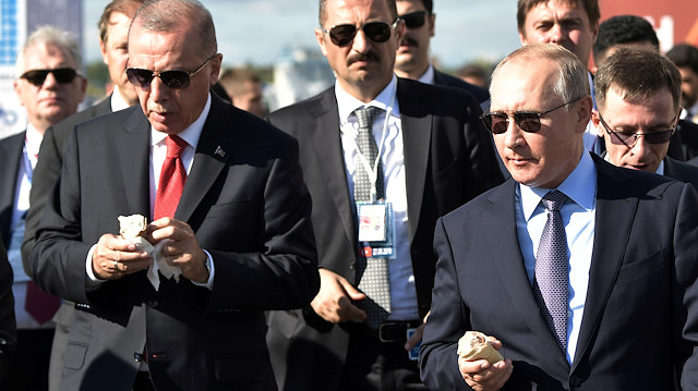Russian President Vladimir Putin and his Turkish counterpart Recep Tayyip Erdogan taste ice-cream as they visit the MAKS 2019 air show in Zhukovsky, outside Moscow, Russia, August 27, 2019. Sputnik/Aleksey Nikolskyi