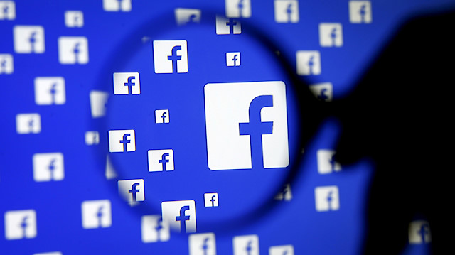 FILE PHOTO: A man poses with a magnifier in front of a Facebook logo on display in this illustration taken in Sarajevo, Bosnia and Herzegovina, December 16, 2015. REUTERS/Dado Ruvic/Illustration/File Photo

