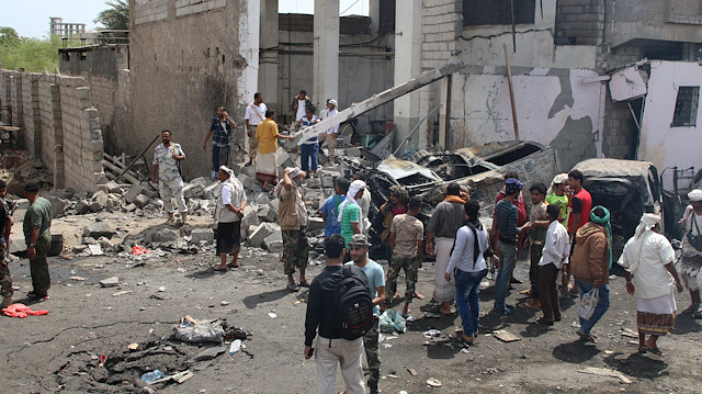 File photo: People inspect the damages after a car bomb ripped through a military kitchen in Aden