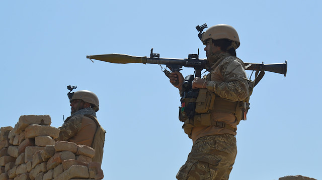File photo: Afghan security forces take position during a battle with the Taliban