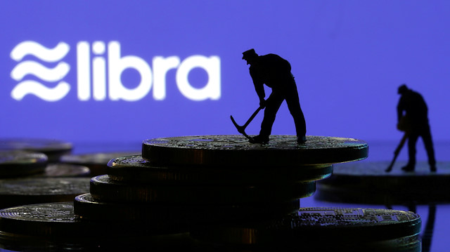 File photo: Small toy figures are seen on representations of virtual currency in front of the Libra logo in this illustration picture