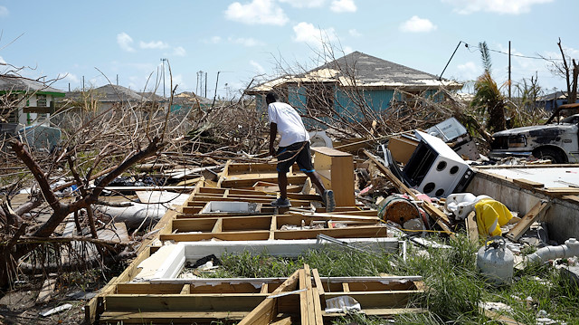 A man walks among the debris of his house after Hurricane Dorian hit the Abaco Islands in Spring City, Bahamas
