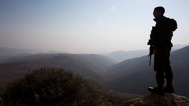 File photo :An Israeli soldier stands guard in the Jordan Valley