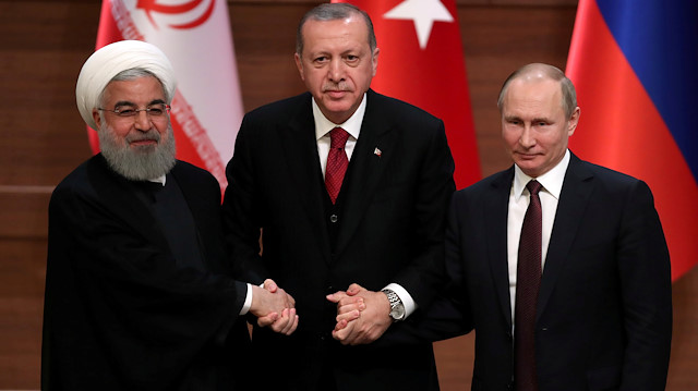 FILE PHOTO: Presidents Hassan Rouhani of Iran, Tayyip Erdogan of Turkey and Vladimir Putin of Russia hold a joint news conference after their meeting in Ankara, Turkey April 4, 2018. REUTERS/Umit Bektas/File Photo  