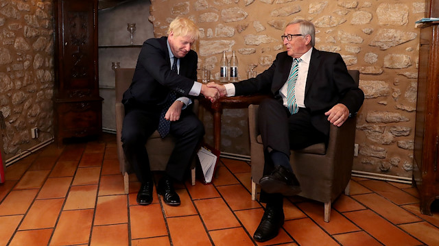European Commission President Jean-Claude Juncker looks on with British Prime Minister Boris Johnson prior to a meeting at a restaurant in Luxembourg.