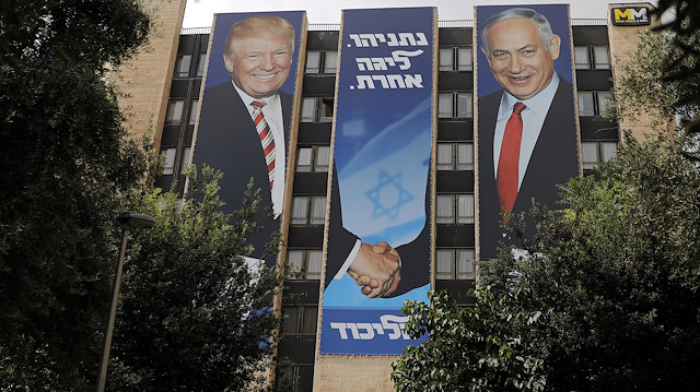 A Likud party election campaign banner depicting Israeli Prime Minister Benjamin Netanyahu shaking hands with U.S. President Donald Trump is seen in Jerusalem September 15, 2019. The Hebrew words read, "Netanyahu, a different league" REUTERS/Ammar Awad


