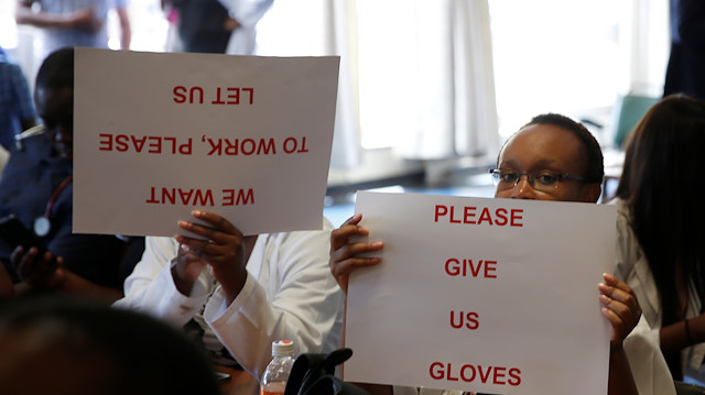 Senior doctors at Parirenyatwa General Hospital, Zimbabwe's biggest medical centre, hold placards during a demonstration to protest a lack of medicines, gloves and bandages in Harare, Zimbabwe March 13, 2019.