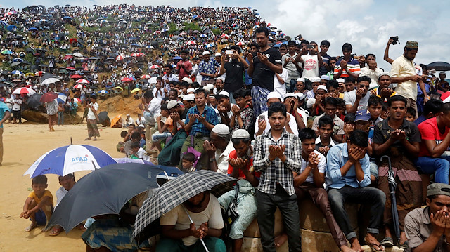 Rohingya refugees take part in a prayer as they gather to mark the second anniversary