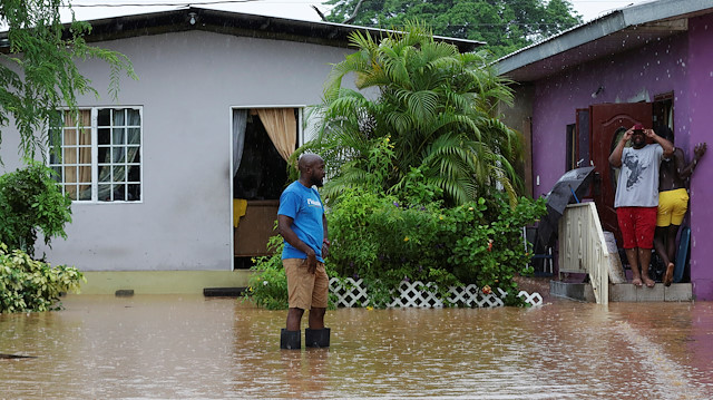 A resident wades through an area flooded by a rain storm caused by Tropical Storm Karen in Barataria, Trinidad and Tobago September 22, 2019.