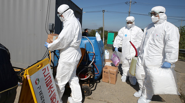 File photo: Quarantine officials wearing protective gear enter a pig farm involved in African swine fever in Paju, South Korea, September 18, 2019. 