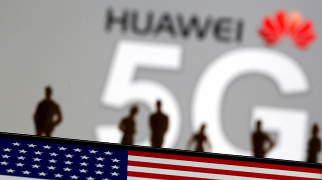 FILE PHOTO: Small toy figures are seen in front of a displayed Huawei and 5G network logo in this illustration picture, March 30, 2019