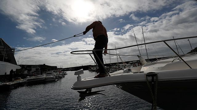 A man reinforces with ropes the mooring of his boat at a port before the arrival of Hurricane Lorenzo in Angra do Heroismo in the Azores islands, Portugal October 1, 2019. 