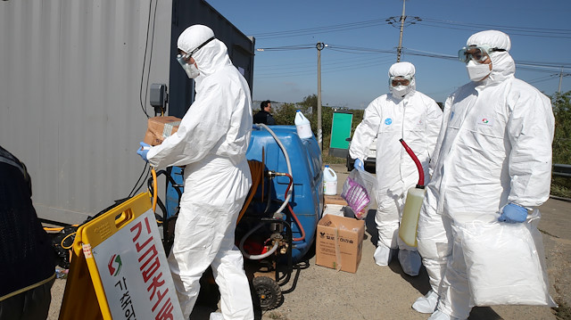 File photo: Quarantine officials wearing protective gear enter a pig farm involved in African swine fever in Paju, South Korea