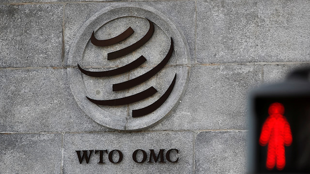 A logo is pictured outside the World Trade Organization (WTO) headquarters next to a red traffic light in Geneva, Switzerland, October 2, 2018. REUTERS/Denis Balibouse/File Photo

