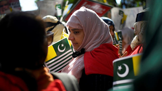 File photo: A woman holds a flag of Azad Kashmir at a protest in solidarity with the people of Kashmir on the sidelines of the United Nations General Assembly in New York, U.S.