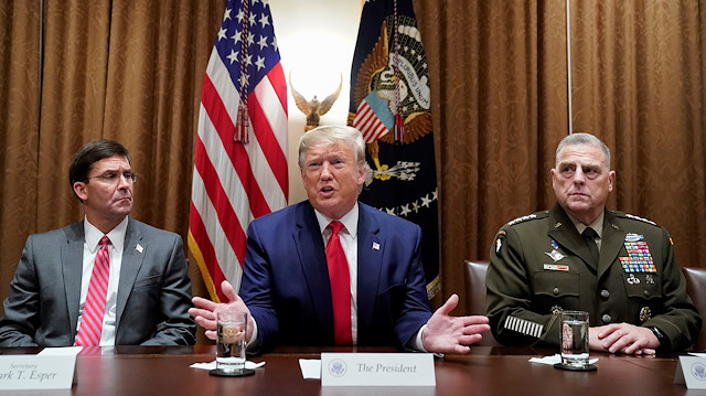 Flanked by Secretary of Defense Mark Esper (L) and Chairman of the Joint Chiefs Army Gen. Mark Milley, U.S. President Donald Trump meets with senior military leaders at the White House in Washington, U.S., October 7, 2019