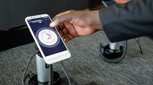 A worker operates a Mara X smartphone during the launch by Rwanda's Mara Group in Kigali