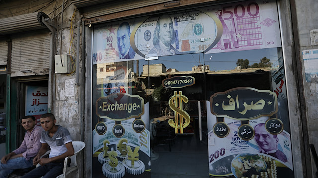 A currency exchange shop decorated with posters of U.S. dollar and Turkish lira is seen in the city of Azaz, Syria August 18, 2018. Picture taken August 18, 2018. REUTERS/ Khalil Ashawi

