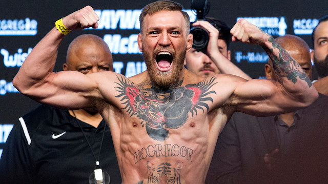 FILE PHOTO: UFC lightweight champion Conor McGregor of Ireland poses on the scale during his official weigh-in at T-Mobile Arena in Las Vegas, Nevada, U.S. on August 25, 2017. REUTERS/Steve Marcus/File Photo


