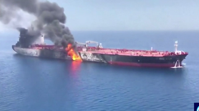 Still image taken from a video appears to show two tankers at sea, one of which has a large plume of dark smoke in the Gulf of Oman. PRESS TV/IRIB/