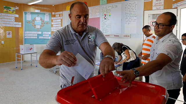 A man casts his ballot during a second round runoff of a presidential election in Tunis