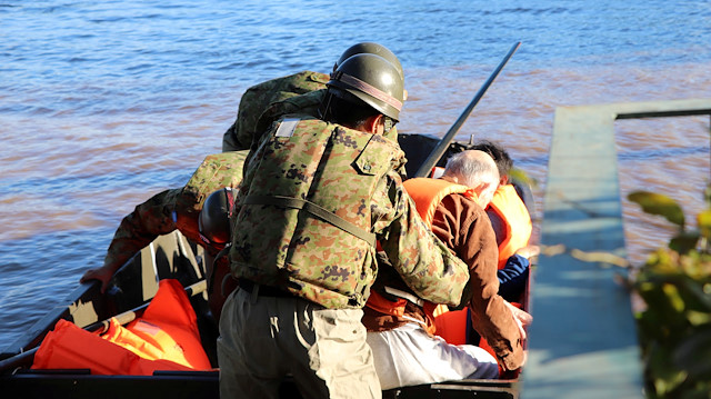 Rescue workers help residents evacuate an area after Typhoon Hagibis swept through Kawagoe, Saitama prefecture, Japan October 13, 2019 in this photo obtained from social media. JGSDF via REUTERS THIS IMAGE HAS BEEN SUPPLIED BY A THIRD PARTY. MANDATORY CREDIT. REFILE - REMOVING RESTRICTION

