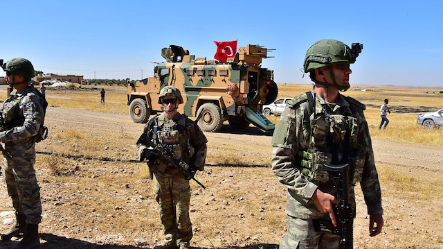 Turkish and U.S. soldiers are pictured during a joint U.S.-Turkey patrol in a Syrian border village near Tel Abyad, Syria, September 8, 2019.Turkish Defence Ministry/