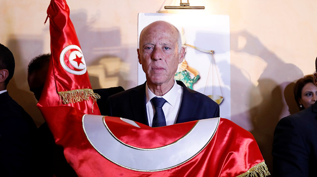 Tunisian presidential candidate Kais Saied reacts after exit poll results were announced in a second round runoff of the presidential election in Tunis