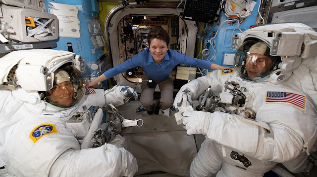 File photo: NASA astronaut Anne McClain assists fellow NASA astronauts Christina Koch (L) and Nick Hague as they verify their U.S. spacesuits are sized correctly and fit properly ahead of a set of upcoming spacewalks at the International Space Station on March 18, 2019. Picture taken on March 18, 2019
