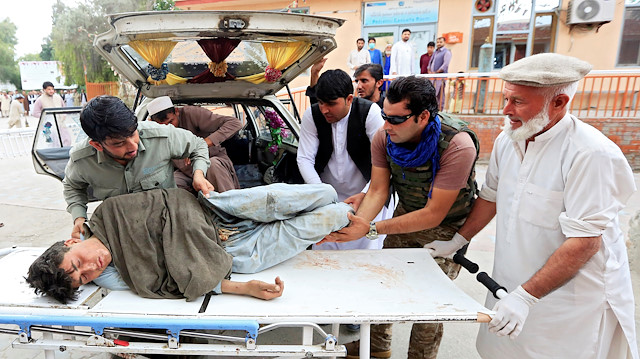 Men carry an injured person to a hospital after a bomb blast at a mosque, in Jalalabad, Afghanistan October 18, 2019. REUTERS/Parwiz

