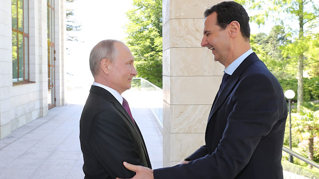 Russian President Vladimir Putin welcomes Syrian President Bashar al-Assad during their meeting in the Black Sea resort of Sochi, Russia May 17, 2018. Sputnik/Mikhail Klimentyev/