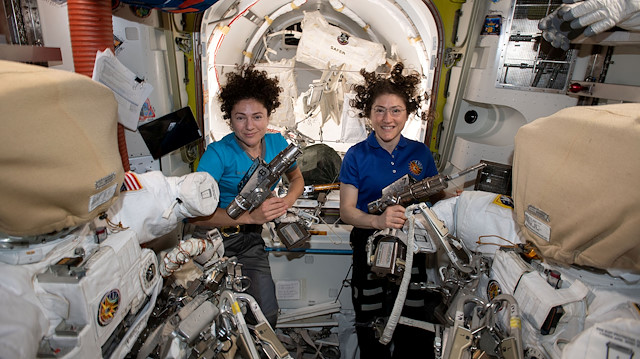 U.S. astronauts Jessica Meir (L) and Christina Koch pose in the International Space Station in a photo released October 17, 2019. 