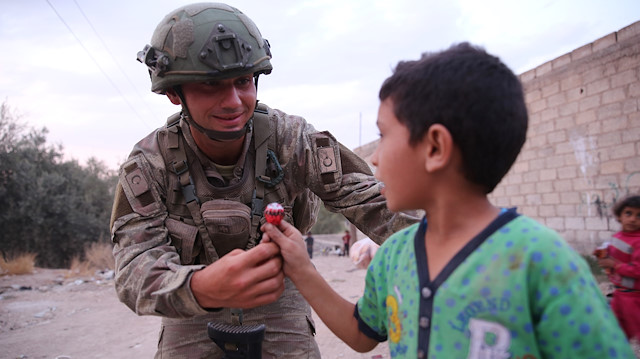 الجندي التركي يرسم البسمة على وجوه أطفال "تل حلف" السورية