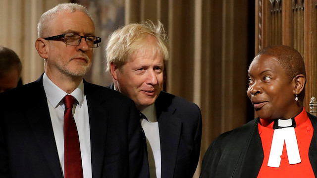 File photo: Britain's Prime Minister Boris Johnson and opposition Labour Party Leader Jeremy Corbyn speak to the Speaker's chaplain Reverend Rose Hudson-Wilkin as they walk through the Commons Members Lobby in Parliament, London, Britain, October 14, 2019