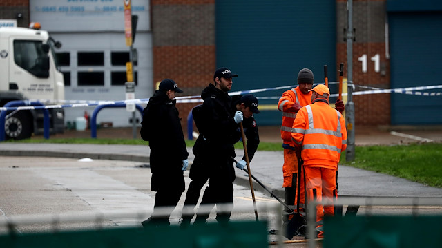 Police officers inspect a drain at the scene where bodies were discovered in a lorry container, in Grays, Essex, Britain October 24, 2019.