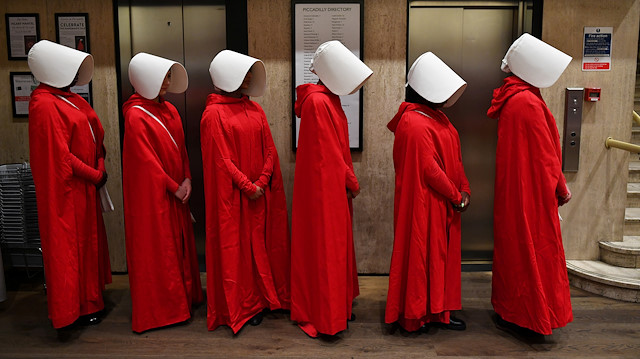 People dressed up as characters from Margaret Atwood's "The Handmaid's Tale" queue to get a copy of her new novel "The Testaments" at Waterstones bookshop in London, Britain, September 9, 2019. REUTERS/Dylan Martinez TPX IMAGES OF THE DAY

