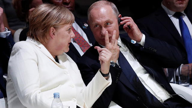 German Chancellor Angela Merkel and Russian President Vladimir Putin attend the opening session of the Paris Peace Forum as part of the commemoration ceremony for Armistice Day, 100 years after the end of the First World War, in Paris, France November 11, 2018. Yoan Valat/Pool via REUTERS

