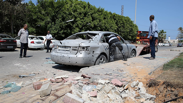 File photo: A Libyan police checks a damaged civilian vehicle, after a missile hit the terminal's park of Mitiga airport in Tripoli, Libya August 24, 2019