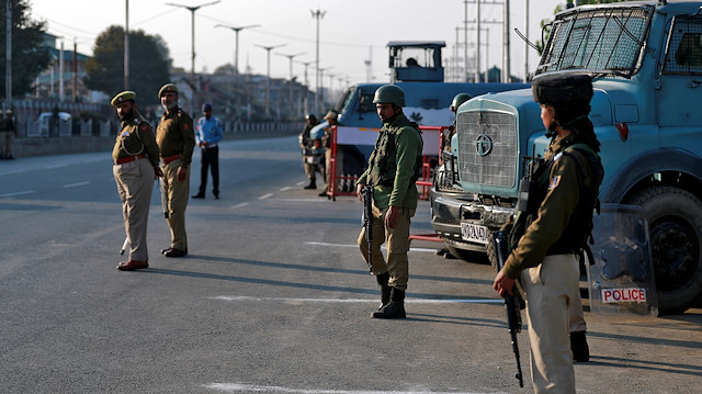 File photo: Indian policemen stand guard on a road in Srinagar 