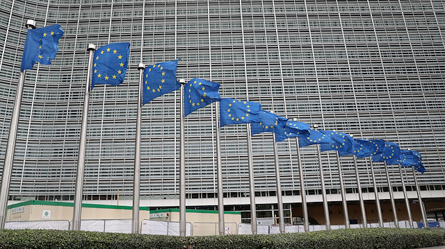 European Union flags fly outside the European Commission headquarters in Brussels, Belgium.