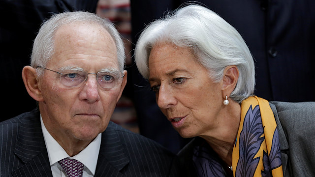 International Monetary Fund (IMF) Managing Director Christine Lagarde talks to German Finance Minister Wolfgang Schaeuble before IMF Governors family photo during the IMF/World Bank annual meetings in Washington, US.
